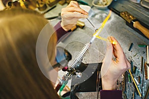 Artist in workshop making glass bead