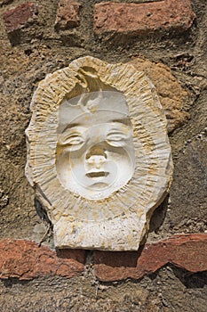 Artistic and architectural details on a wall at Volterra, Tuscany