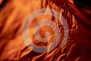 artistic background shot of orange inside of bivouac sack against morning sun ight