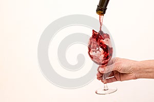 Artistic beautiful picture. Red wine is poured into a glass