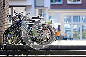 Artistic City View - parked bicycles against the backdrop of residential buildings. Beautiful morning light. Focus on the