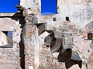 Artistic composition of an ancient broken brick wall and unique stairs made of black stone.