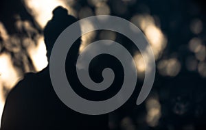 Artistic concept: A man's shadow on a white wall forms a Buddha Statue resemblance. Serene and evocative