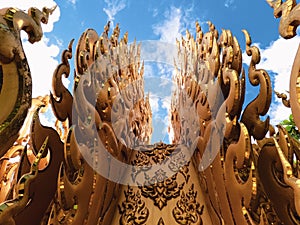 Artistic details close up of Golden sculpture or Statue of white Buddha in Wat Rong Khun Chiang Rai