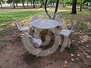 Artistic hands shaped concrete garden chairs and table.