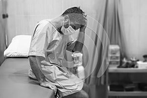 Artistic hospital portrait of attractive and scared man infected by covid19 -  adult male in face mask at clinic suffering