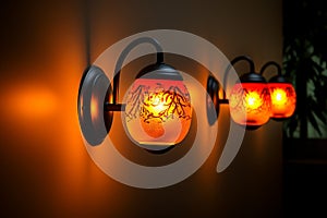 Artistic illumination wallmounted lamp casts a warm yelloworange glow
