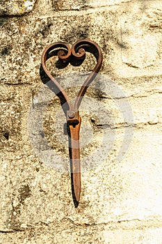 Artistic, iron sculpture, affixed, to limestone wall