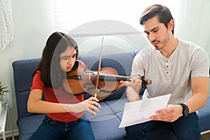 Artistic kid learning to play a musical instrument