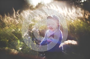 Artistic look portrait of a child in nature, smiling boy