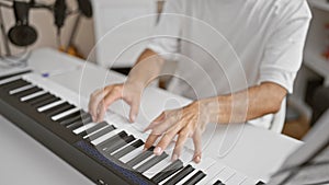 Artistic man\'s hands strum passionate melody on acoustic piano