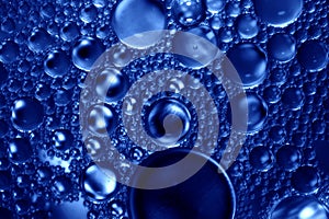 Artistic photo of oil drops close up in blue tones for background