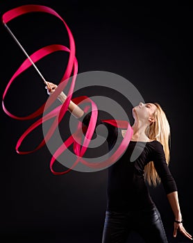 Artistic photo of rhytmic gymnast with ribbon