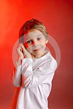 Artistic portrait of a child, boy, lightened with gel filters, studio shot