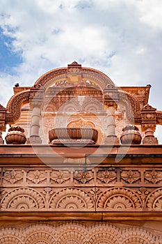 artistic red stone jain temple at morning from unique angle