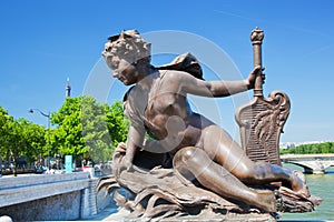 Artistic statue on Alexandre Bridge against Eiffel Tower. Paris, France