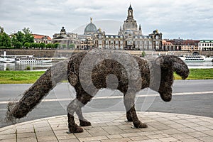 Artistic statue vulpes gott in front of Supreme Land Court palace in Dresden, Germany