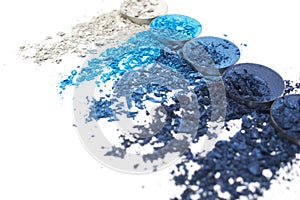 Artistic style crashed eyeshadow in different shades of blue on white background