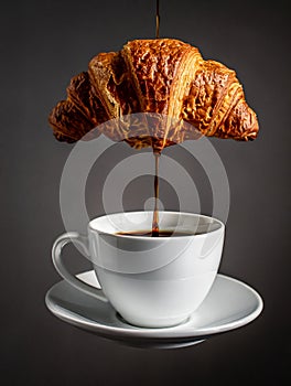 Dynamic zero-gravity coffee-pour with floating croissant and mug.