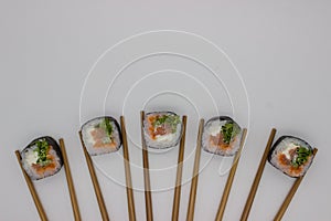 Artistic Sushi Presentation with Chopsticks on White Background