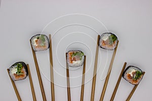 Artistic Sushi Presentation with Chopsticks on White Background