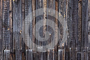 Artistic texture of an old wooden fence in black and brown tones - close-up rustic background
