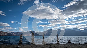 Artistically balanced stones in Pangong Lake