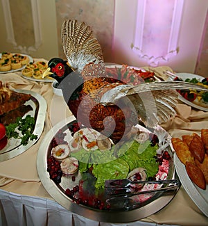 Artistically decorated dish is a delicacy from the chef - a dish of wild game - bird with dried apricots. appetizer buffet