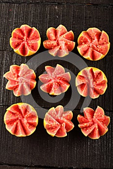 Artistically sliced red guava fruits,