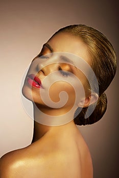 Artistry. Fanciful Bronzed Woman's Face. Futuristic Art Gold Makeup