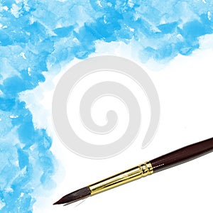 artists brush and blue watercolor painted