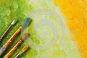 Artists brushes on artistic background