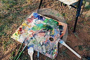 Artists brushes and oil paints on wooden palette. macro artist`s palette
