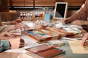 Artists drawing with soft pastels at table, closeup