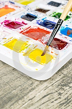 An artists paint brush and a paint box
