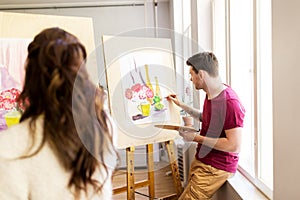 Artists painting still life picture at art school