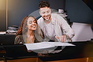 Artists, piano and people playing music in a creative or recording studio with a song book. Art, musicians and couple in