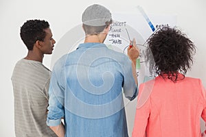 Artists using whiteboard in creative office