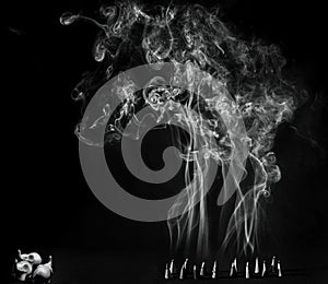 Artitic black and white view of burning incense cones with intense smoke