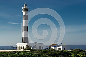 Artrutx lighthouse with black and white striped tower