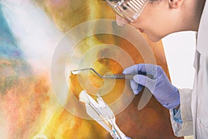 Artwork conservator at work