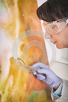 Artwork conservator at work