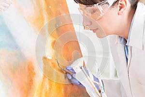 Artwork conservator at work