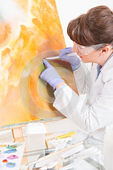 Artwork conservator at work