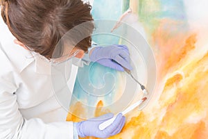 Artwork conservator at work