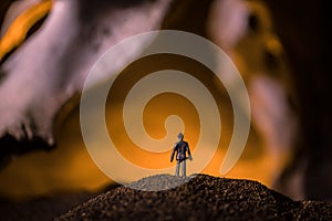 Artwork decoration with animal bone. Silhouette in an underground abandoned crypt. man standing in front of a cave entrance