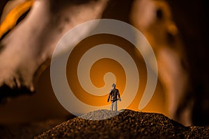 Artwork decoration with animal bone. Silhouette in an underground abandoned crypt. man standing in front of a cave entrance