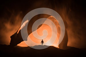 Artwork decoration with animal bone. Silhouette in an underground abandoned crypt. man standing in front of a cave entrance