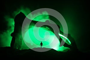 Artwork decoration with animal bone. Silhouette in an underground abandoned crypt. man standing in front of a cave entrance