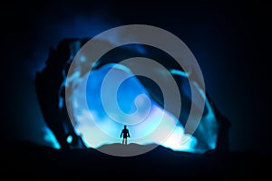 Artwork decoration with animal bone. Silhouette in an underground abandoned crypt. man standing in front of a cave entrance